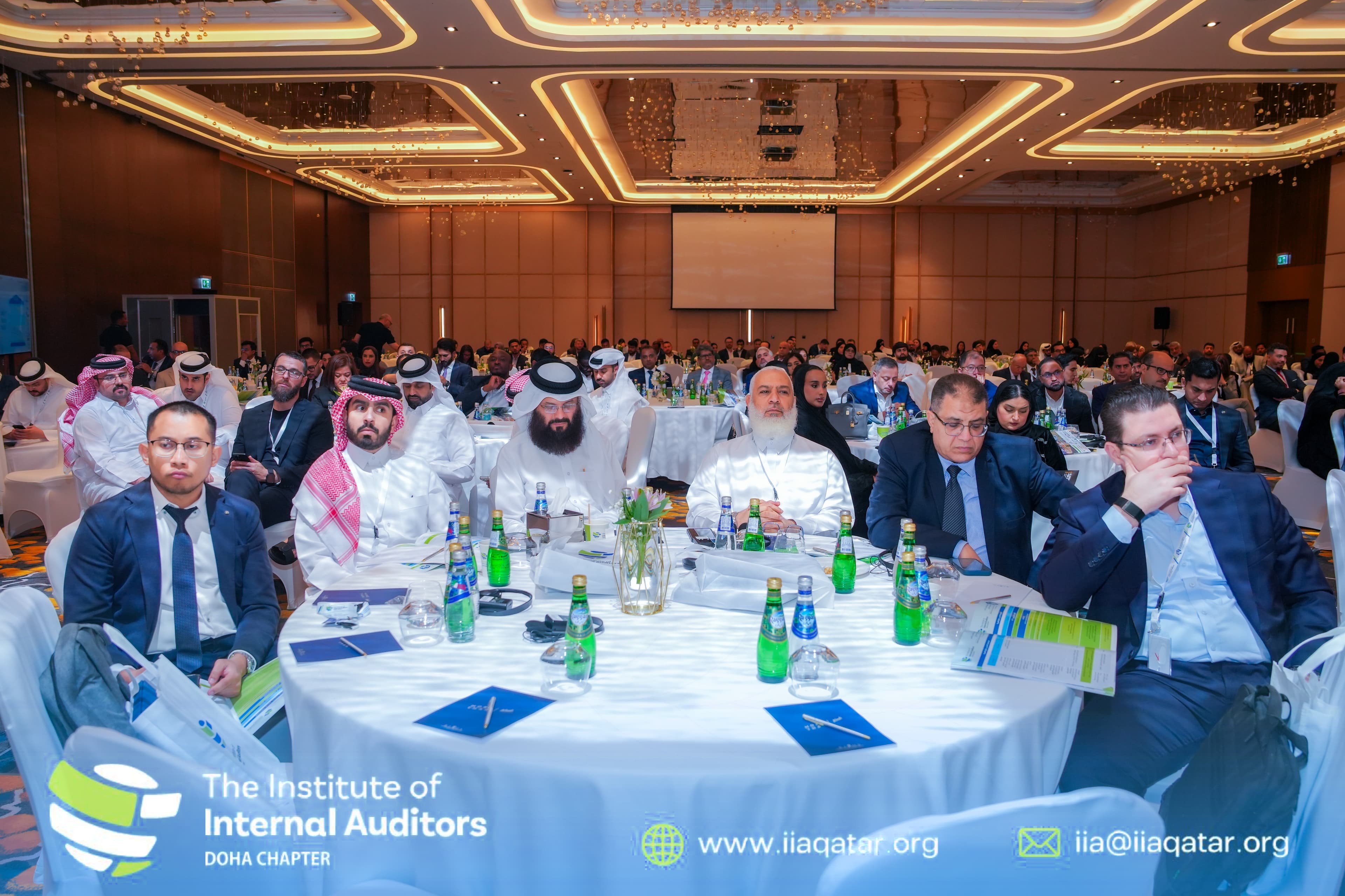 Delegates seated around a conference table at an internal auditing summit