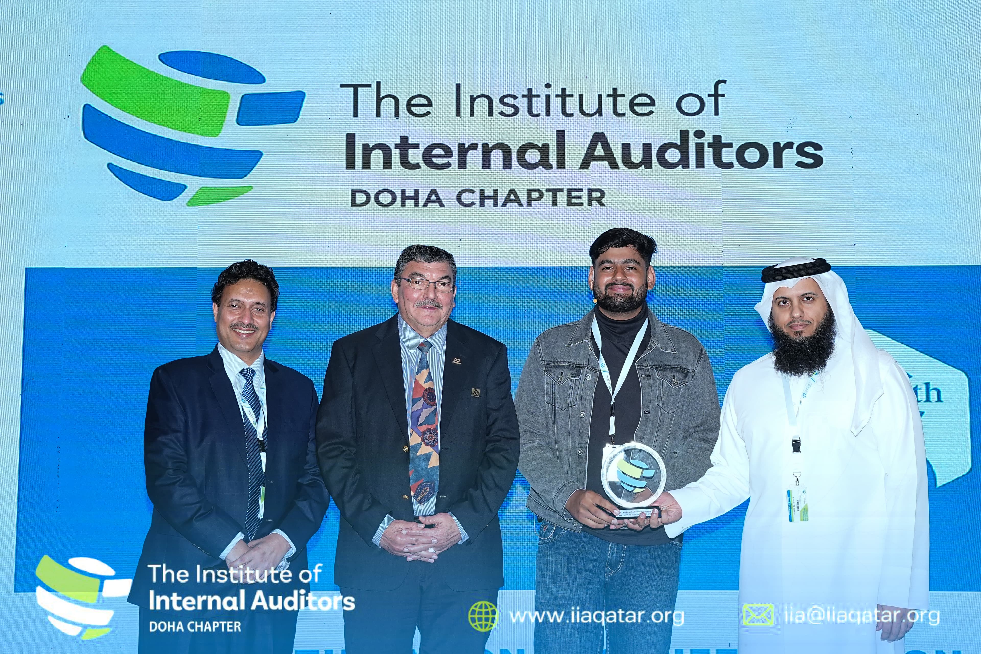 Award recipient posing with organizers on stage